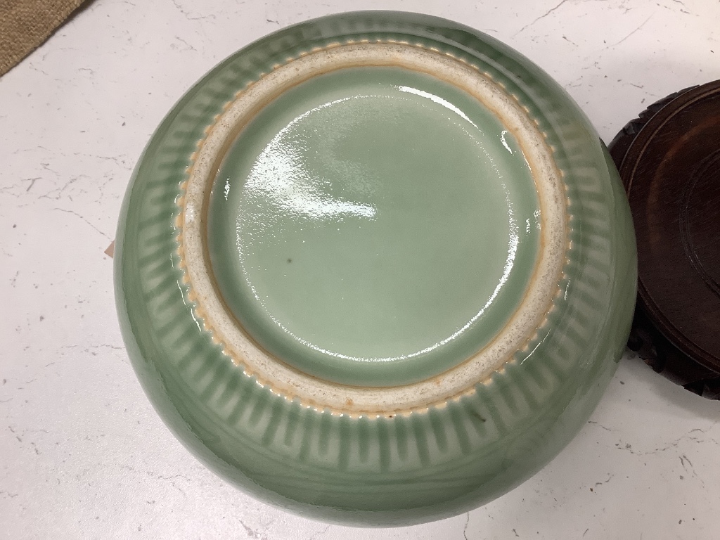 A Chinese circular celadon dish with scalloped rim, diameter 36cm, and a similar bowl, both with stands